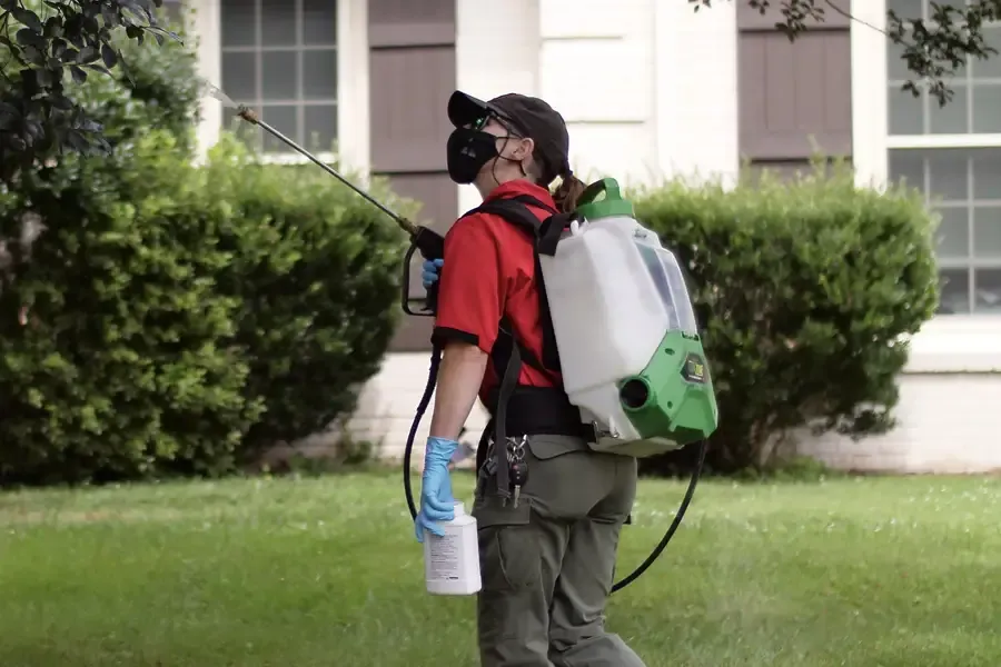 tech spraying in back yard