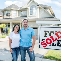 New homeowners in front of house