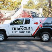 Triangle Pest Control truck providing charlotte winter pest control services in a residential neighborhood