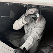 Triangle Pest Control technician inspecting a crawlspace during winter rodent control in Raleigh NC.”